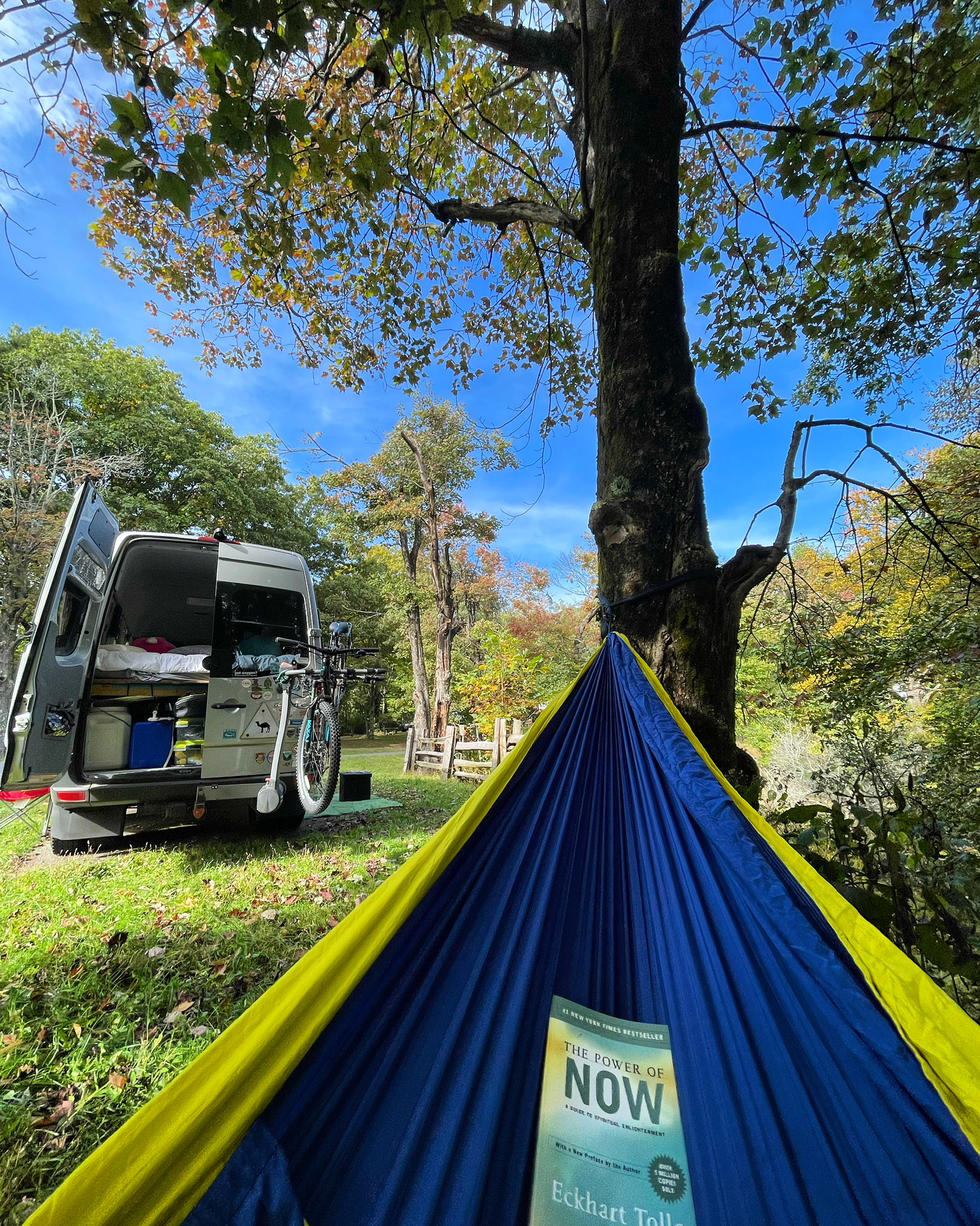 Wilson’s expedition van beside a hammock under autumn trees